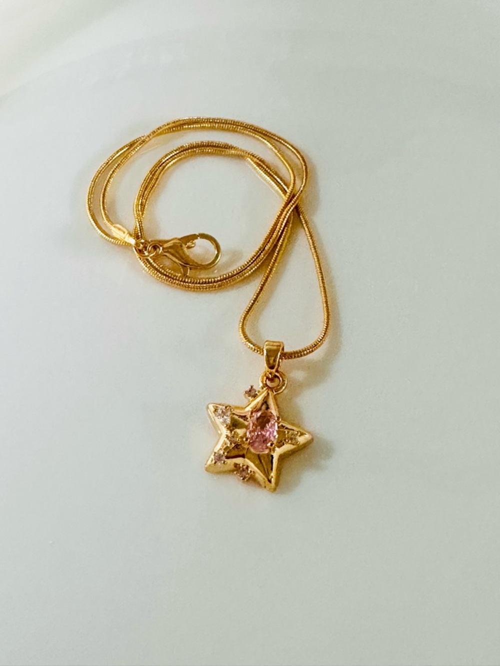 Gold Star Pendant Necklace with Pink Crystal Accent by
